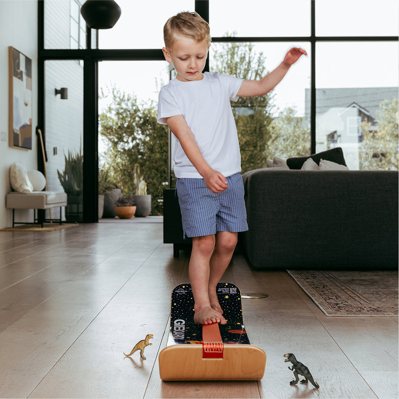 Child balancing on an Astro SlackBoard at home