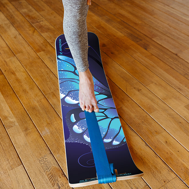 Person standing on Butterfly SlackBoard on a wooden floor