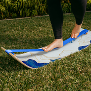 Person balancing on a Mountain Slackboard over grass