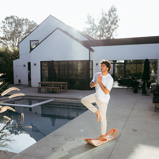 Yoga pose on a Sunbeam SlackBoard by the pool